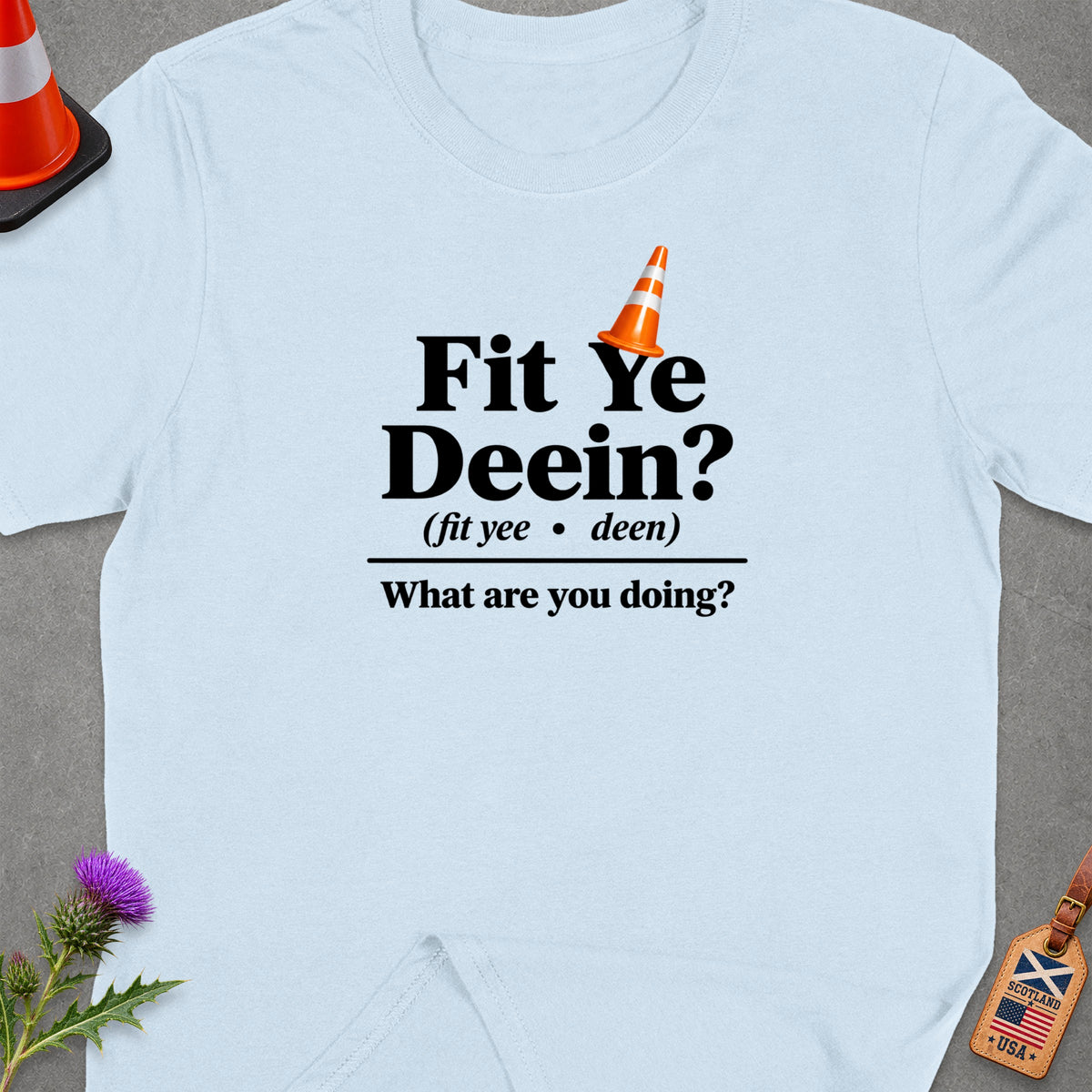 Light blue t-shirt with "Fit Ye Deein?" and "What are you doing?" text.