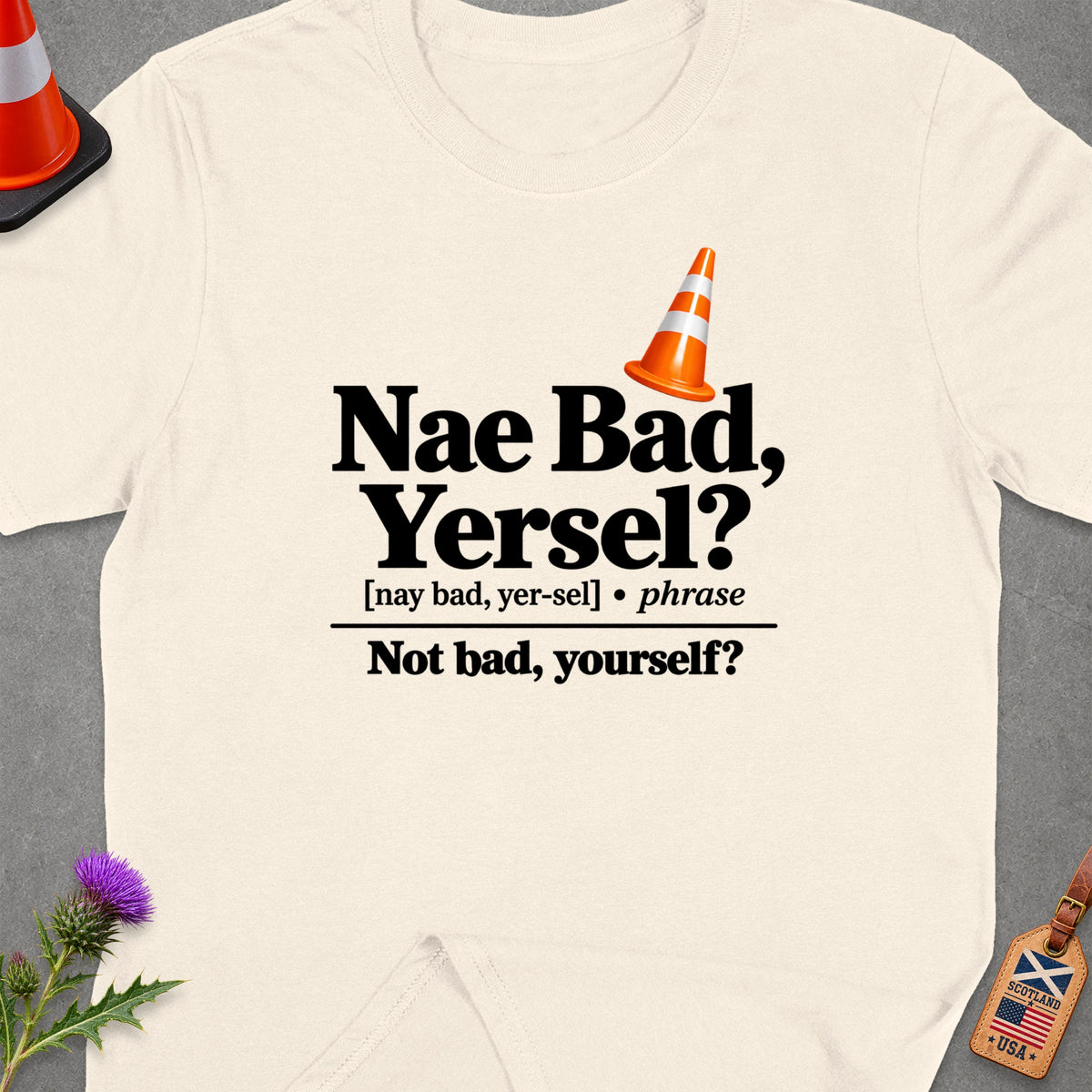 T-shirt with "Nae Bad, Yersel?" text, traffic cone, and Scotland/USA luggage tag.