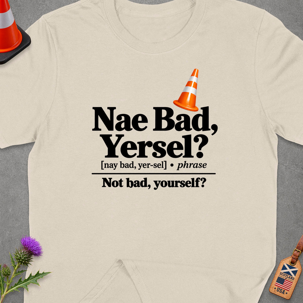 Cream t-shirt with "Nae Bad, Yersel?" text and orange traffic cone.