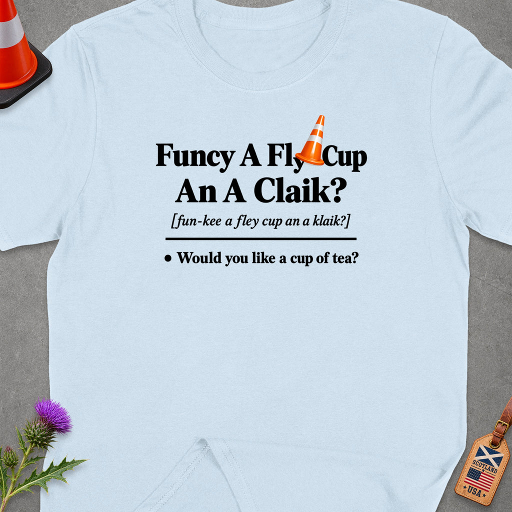 Light blue t-shirt with "Funcy A Fly Cup An A Claik?" and tea question.