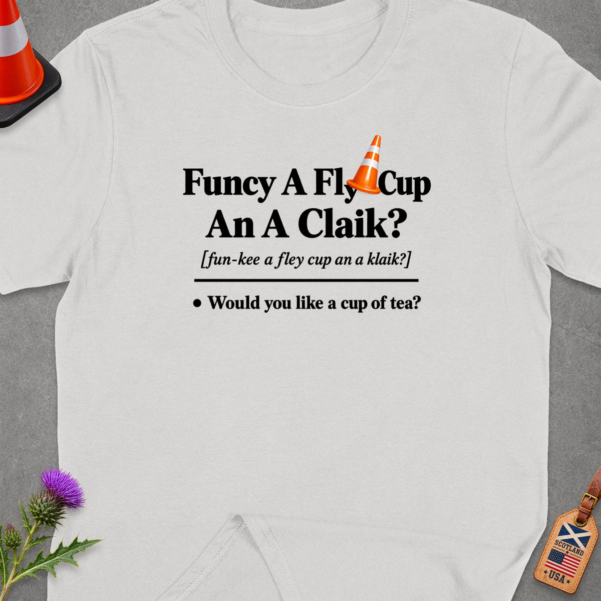 White t-shirt with black text: "Funcy A Fly Cup An A Claik?" and "Would you like a cup of tea?"