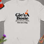 White t-shirt with "Gie's A Bosie Give me a hug" text and an orange traffic cone.