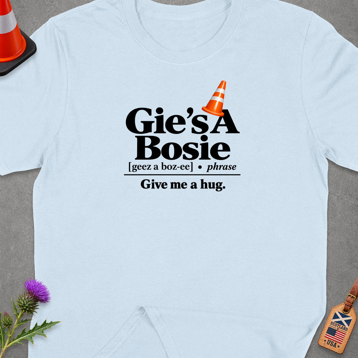 Light blue t-shirt with "Gie's A Bosie" and "Give me a hug." text.