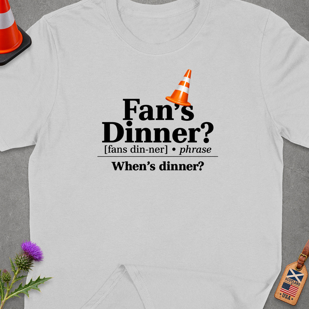 White t-shirt with "Fan's Dinner? When's dinner?" text and orange traffic cone.