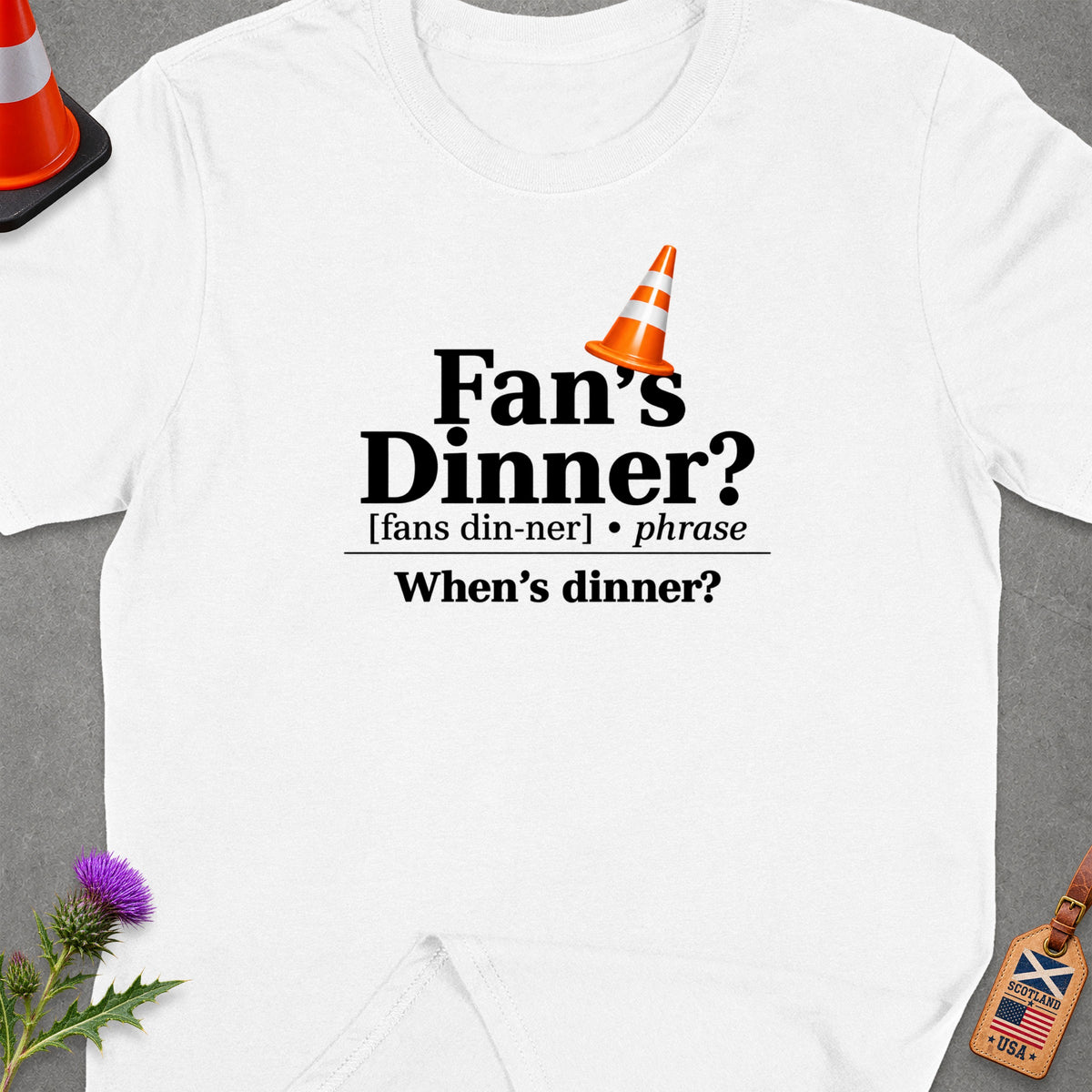 White t-shirt with "Fan's Dinner? When's dinner?" text and traffic cone graphic.