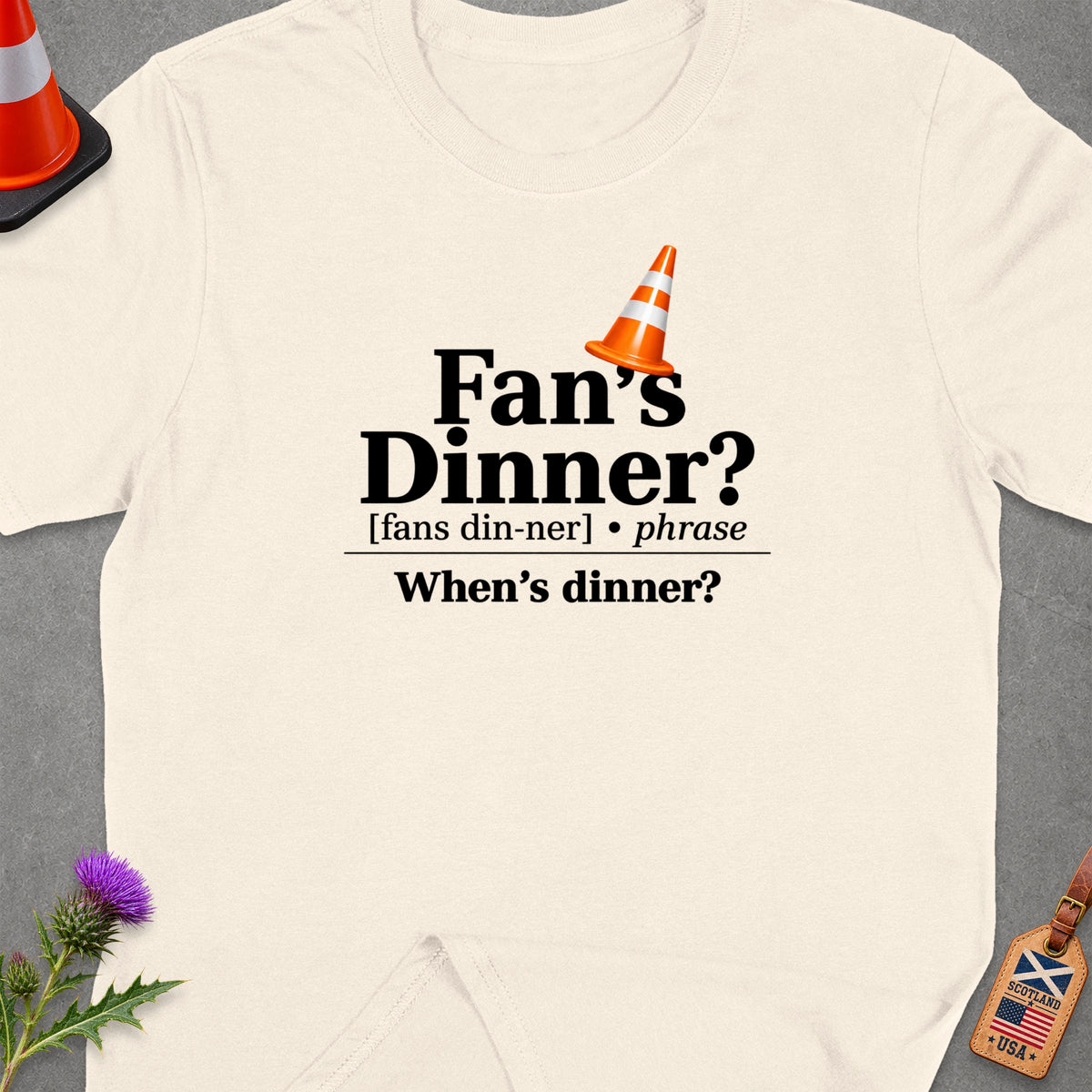 Cream t-shirt with "Fan's Dinner? When's dinner?" text and traffic cone.