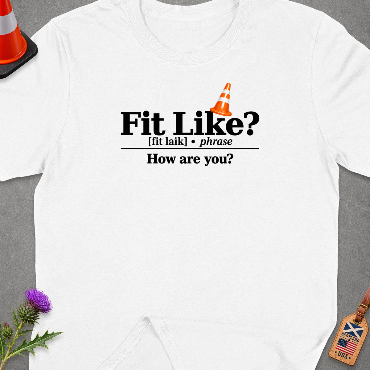 White t-shirt with "Fit Like? How are you?" text and traffic cone graphic.