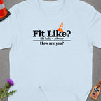 Light blue t-shirt with "Fit Like? [fit laik] phrase How are you?" text.