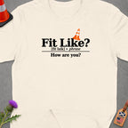 Cream t-shirt with "Fit Like? How are you?" text and a traffic cone graphic.