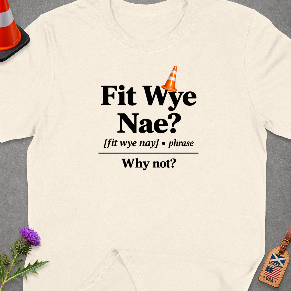 Cream t-shirt with "Fit Wye Nae? Why not?" text and traffic cone graphic.