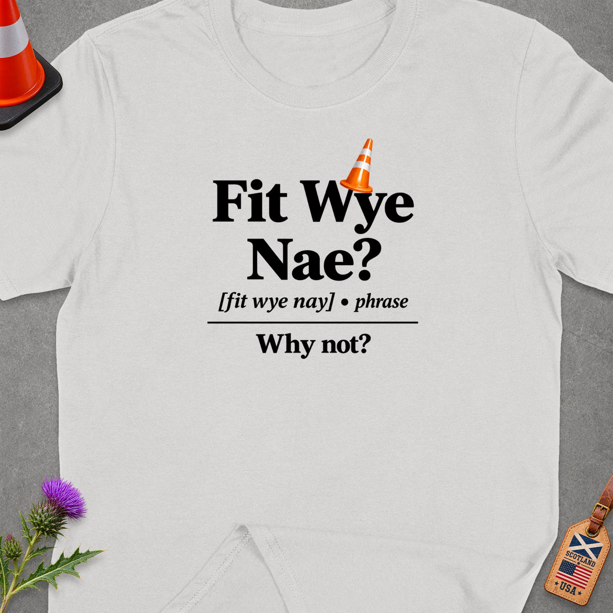 White t-shirt with "Fit Wye Nae? Why not?" text and orange traffic cone graphic.