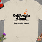 Cream t-shirt with black text reading "Quit Footerin Aboot!" and "Stop messing around!".