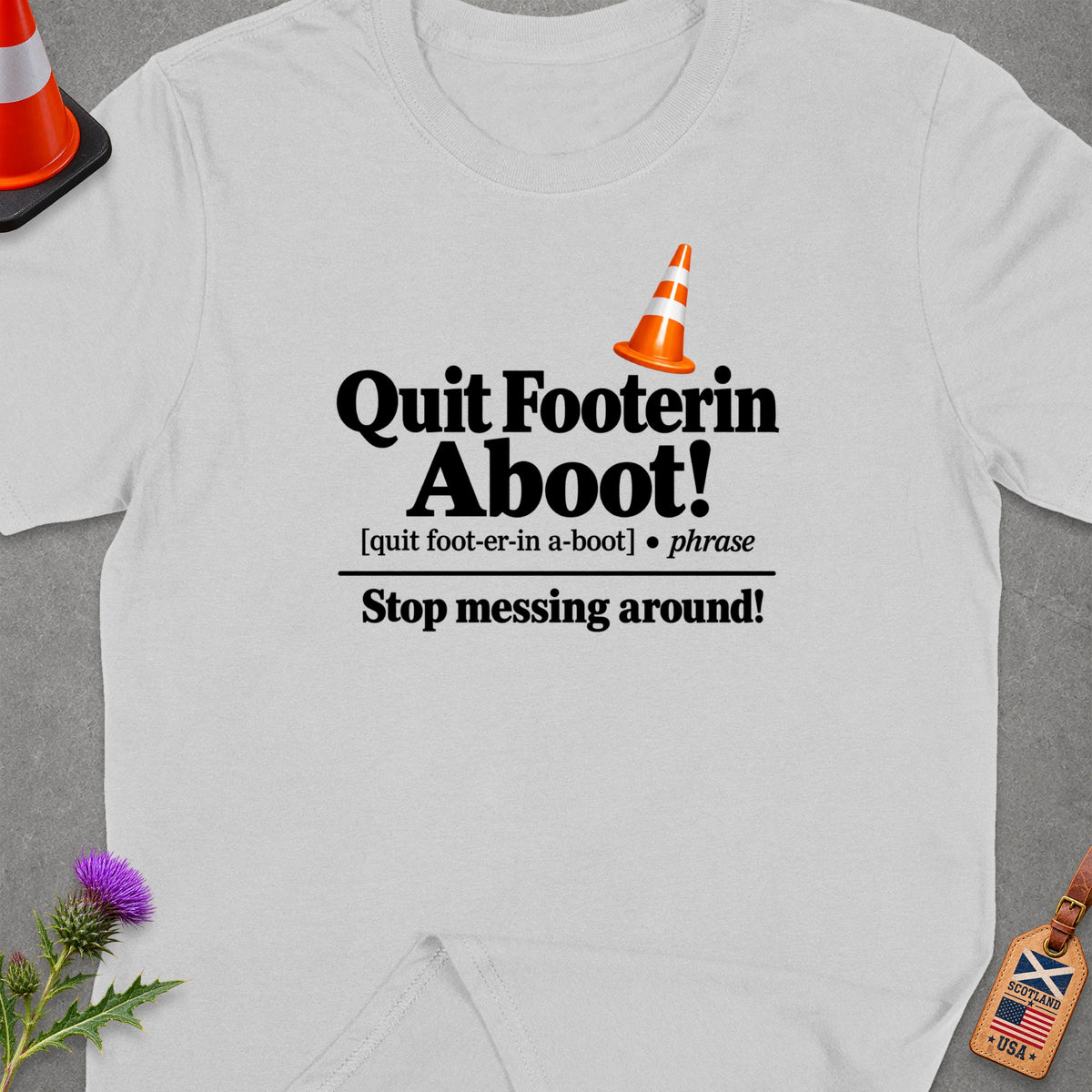 Light grey t-shirt with "Quit Footerin Aboot! Stop messing around!" text.