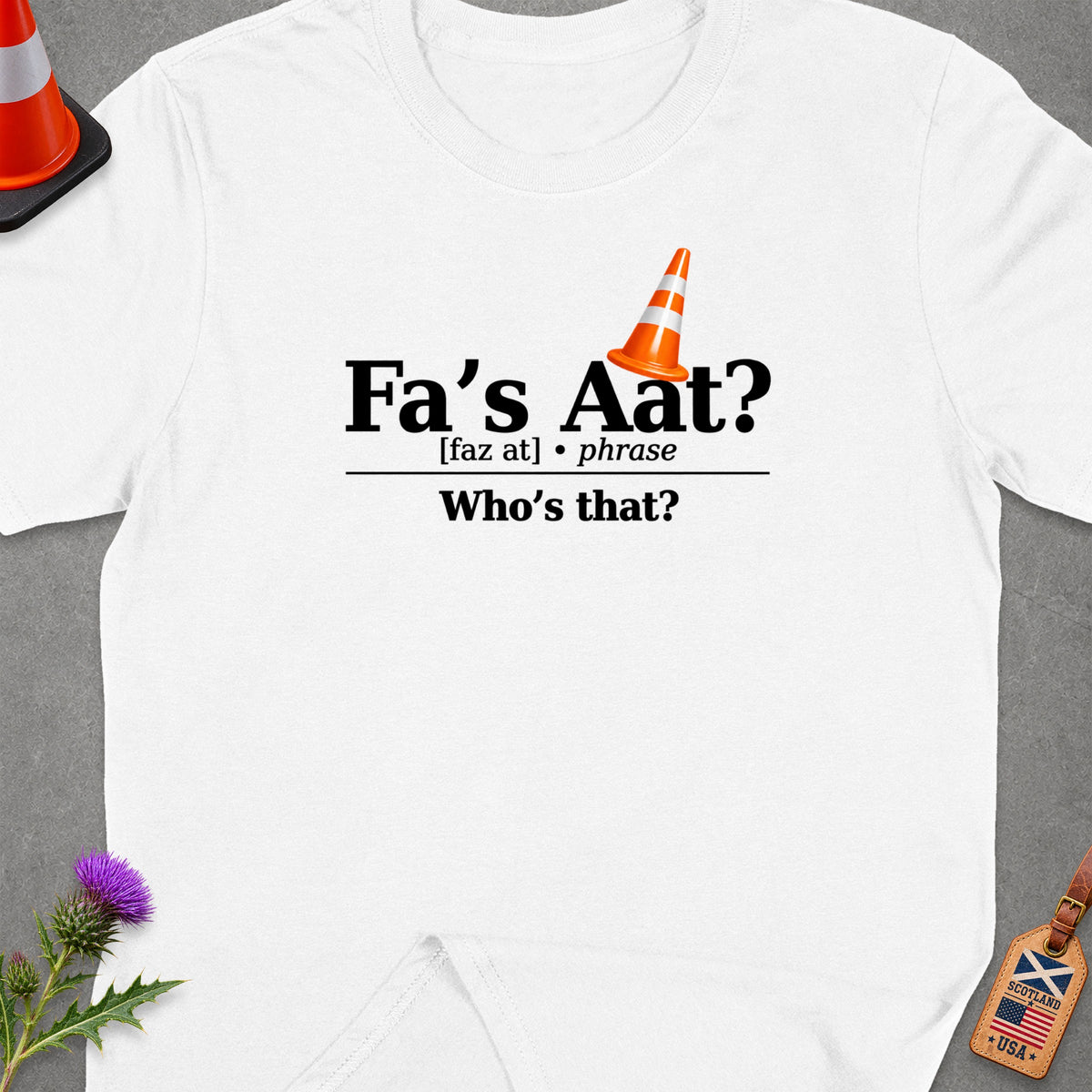 White t-shirt with text "Fa's Aat? Who's that?" and a traffic cone graphic.