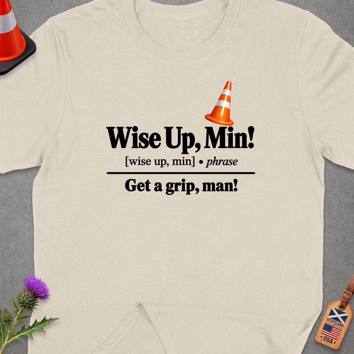Cream t-shirt with "Wise Up, Min!" and "Get a grip, man!" text.