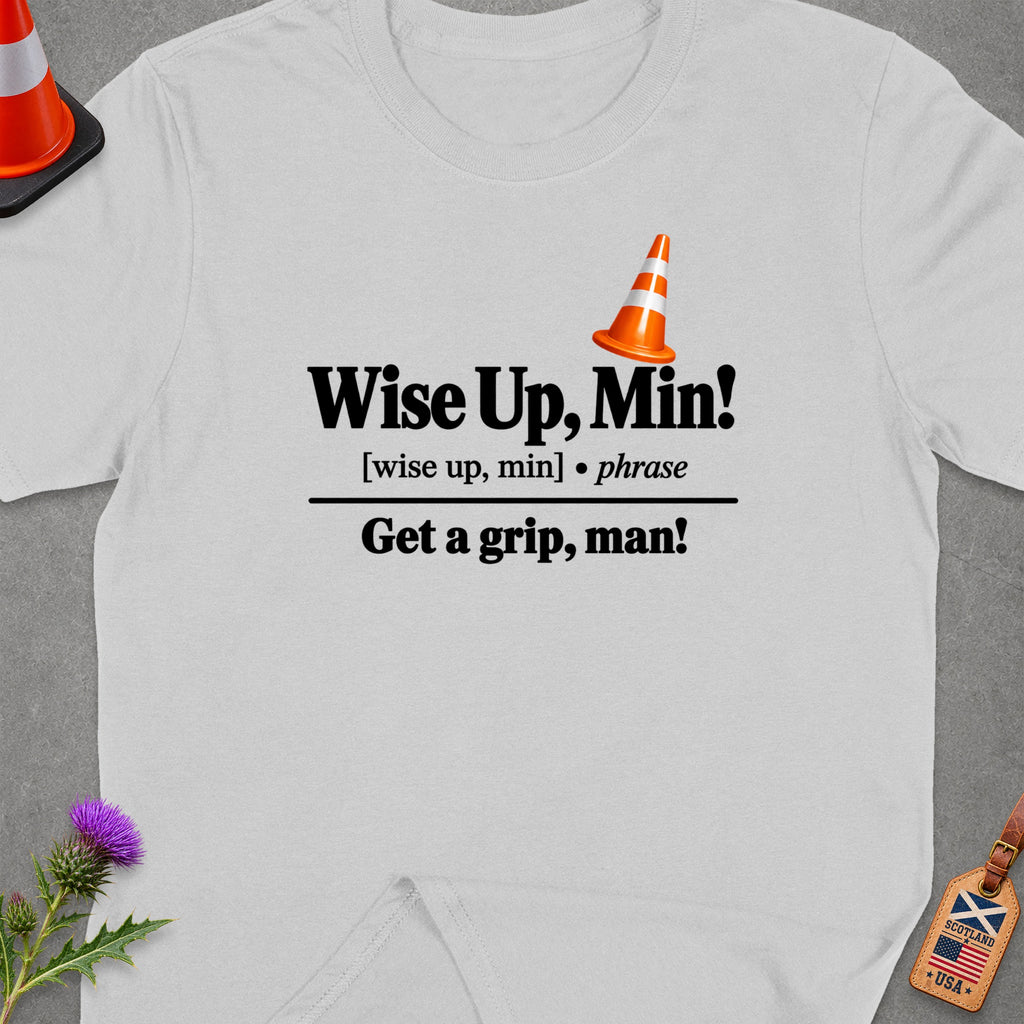 White t-shirt with black text "Wise Up, Min!" and "Get a grip, man!".