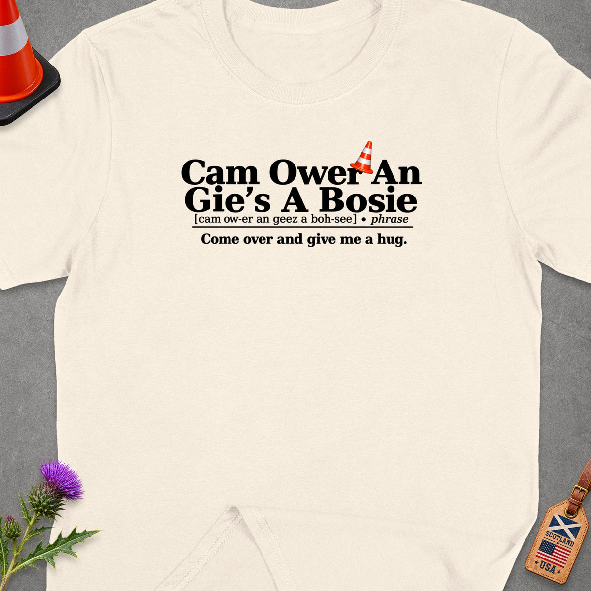 Cream t-shirt with "Cam Ower An Gie's A Bosie" and "Come over and give me a hug." text.