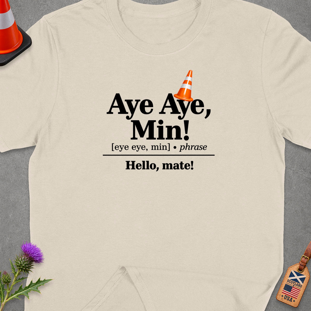 Light beige t-shirt with "Aye Aye, Min!" and "Hello, mate!" text.