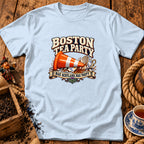 Light blue t-shirt displaying a graphic of a traffic cone inside a broken teacup with Boston Tea Party text.