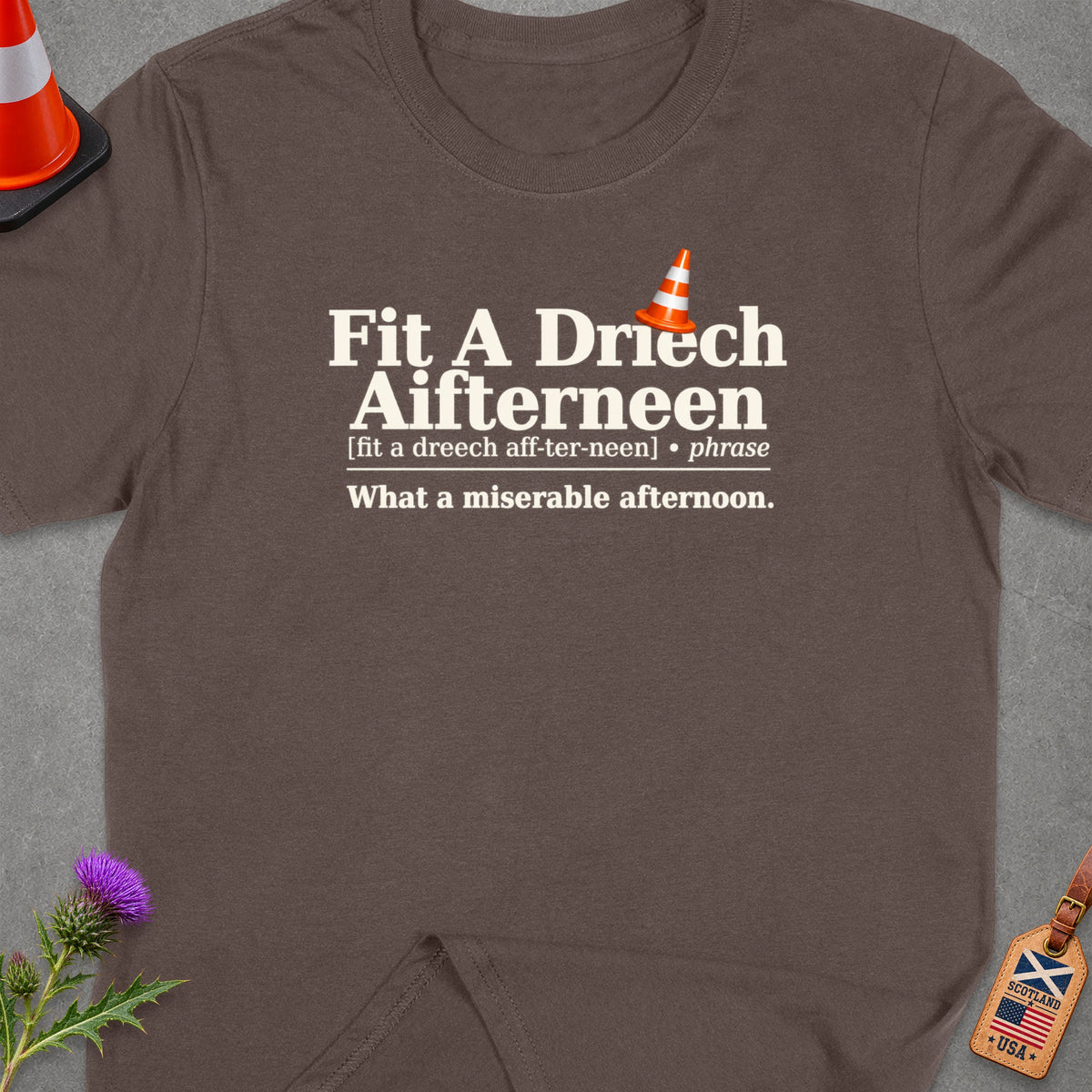 Brown t-shirt with text "Fit A Driech Aifterneen" and "What a miserable afternoon."