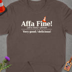 Brown t-shirt with "Affa Fine!" phrase definition and Scotland/USA luggage tag.