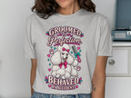T-shirt graphic with text "GROOMED TO PERFECTION. BEHAVED BY ACCIDENT" and a poodle.