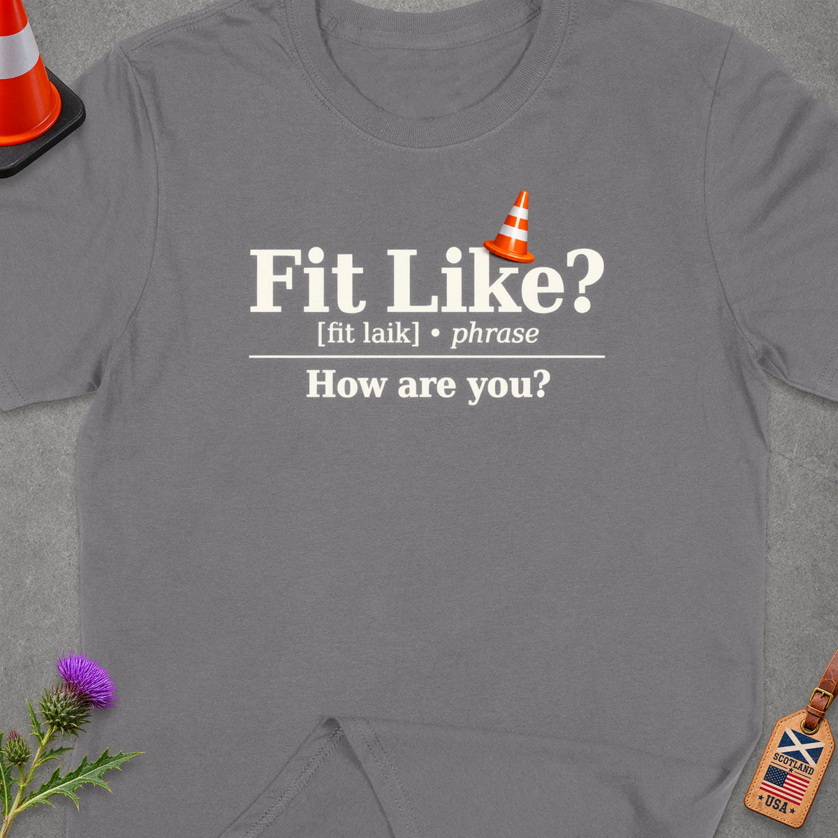 Grey t-shirt with "Fit Like? How are you?" text and a traffic cone.