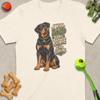 Rottweiler illustration on a cream t-shirt with text "I Work Hard So My Rottie Can Judge Me".