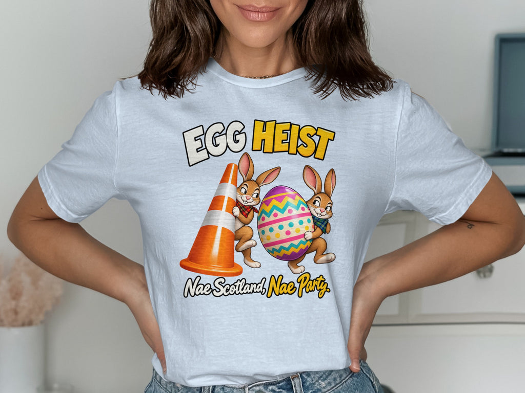 T-shirt graphic: "EGG HEIST" with two cartoon bunnies holding an egg and traffic cone.