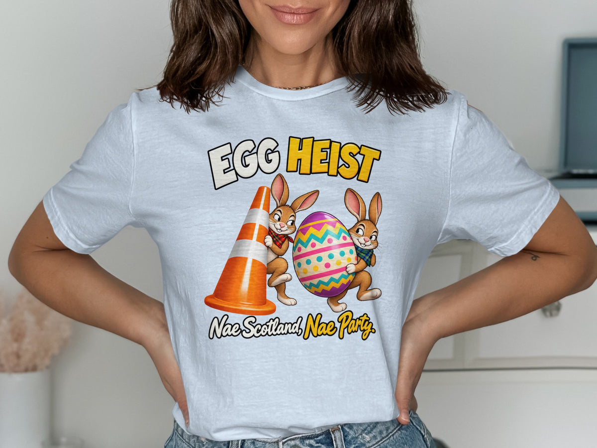 T-shirt graphic: "EGG HEIST" with two cartoon bunnies holding an egg and traffic cone.