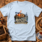 A light blue t-shirt with a graphic of a Scottish-themed Boston Tea Party illustration.