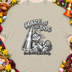 Bunny in scarf drinks coffee beside cone and basket of eggs, with text "Hare of the Dog".