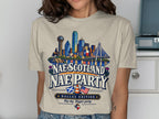 Dallas skyline with cowboy, Scottish and US flags, and text "Nae Scotland Nae Party".