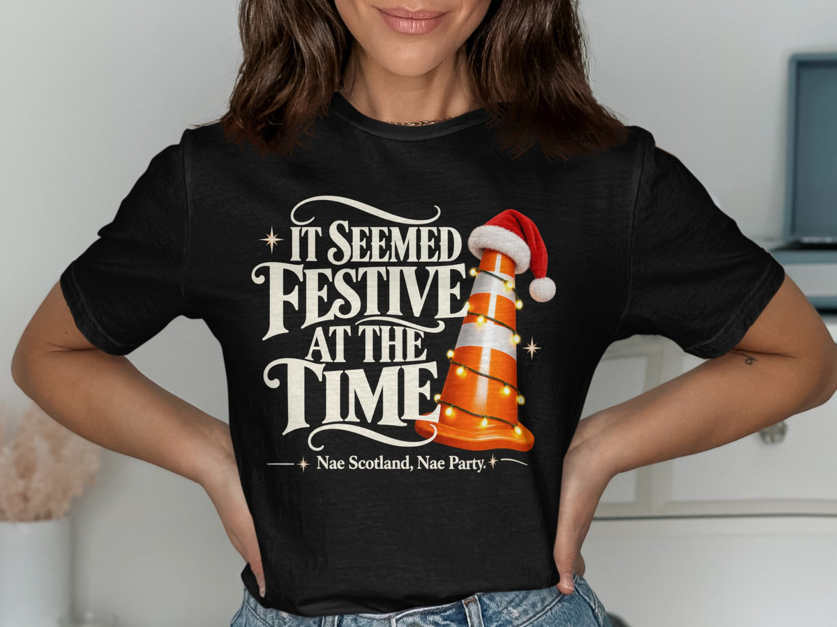 Black t-shirt with "It Seemed Festive At The Time" and traffic cone.