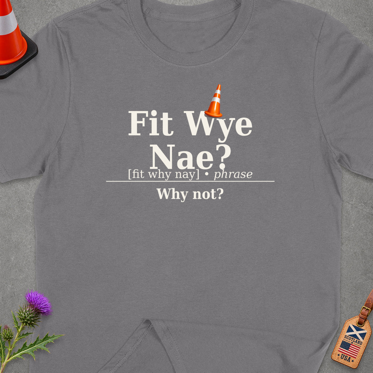 Grey t-shirt with "Fit Wye Nae? Why not?" and a construction cone graphic.