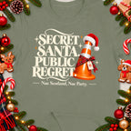 T-shirt with "Secret Santa Public Regret" and traffic cone with Santa hat.