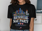 Black t-shirt graphic with Houston skyline, shuttle, and text "NAE SCOTLAND NAE PARTY HOUSTON EDITION".