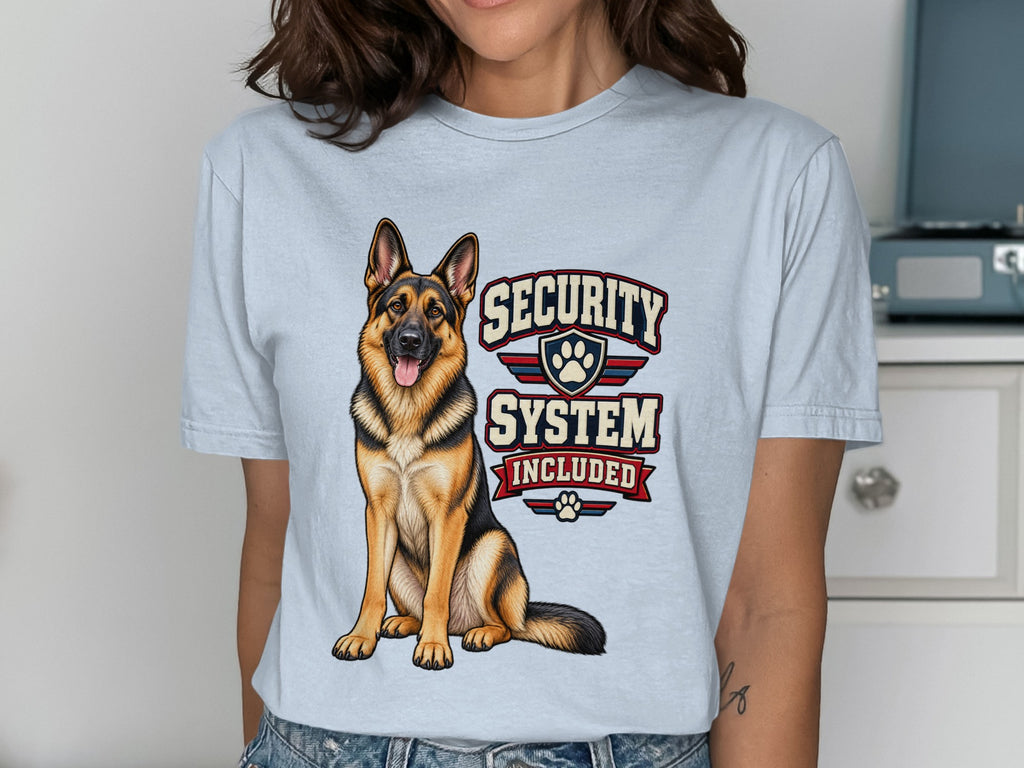 German Shepherd with text "Security System Included" on light blue t-shirt.