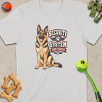 German Shepherd graphic with "Security System Included" text on a white t-shirt.