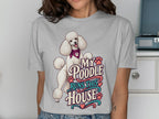 White poodle with bandana on t-shirt reading "My Poodle Runs This House".
