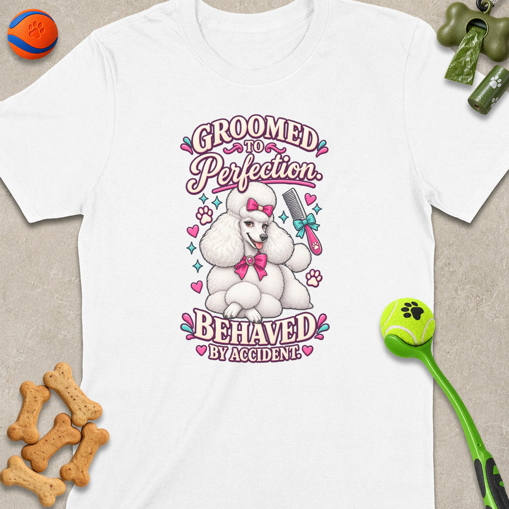 White t-shirt with a graphic of a poodle saying "Groomed to Perfection. Behaved by Accident."