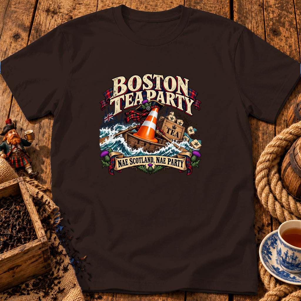 Dark brown t-shirt featuring a humorous graphic of a boat with a traffic cone dumping tea crates into the sea, with the text Boston Tea Party and Nae Scotland, Nae Party.