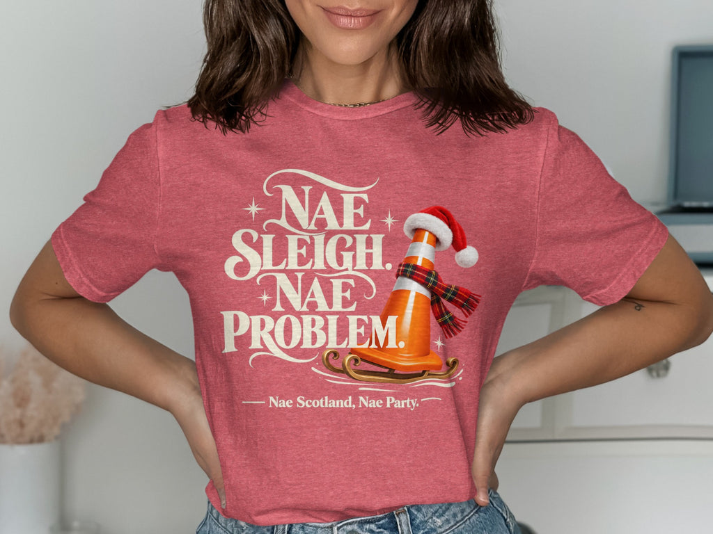 Red t-shirt with "Nae Sleigh, Nae Problem" and a traffic cone on a sled.