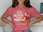 Red t-shirt with "Nae Sleigh, Nae Problem" and a traffic cone on a sled.