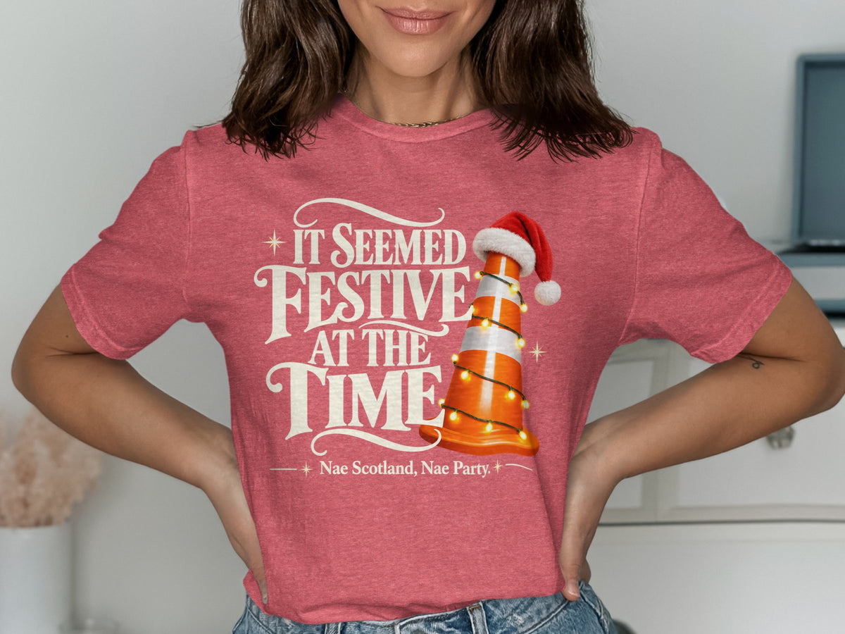 Red t-shirt with text "It Seemed Festive At The Time" and a traffic cone with Santa hat.