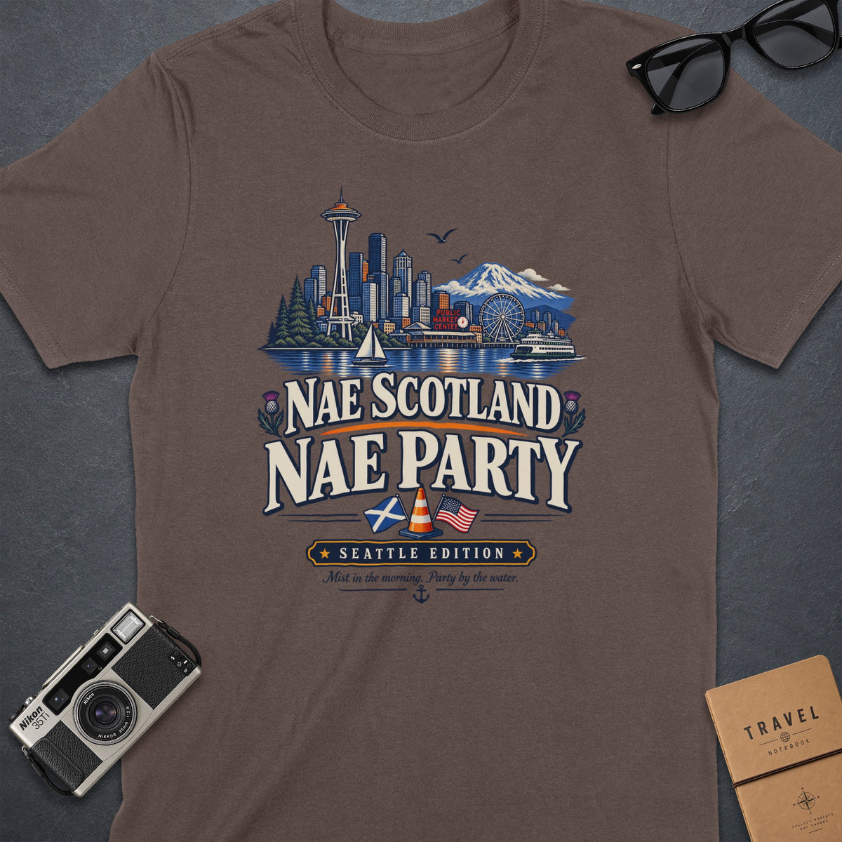 Brown t-shirt with Seattle skyline graphic and "Nae Scotland Nae Party" text.