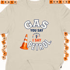 Cream t-shirt with "GAS YOU SAY I SAY PETROL" graphic and orange traffic cone.