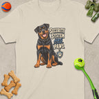 Rottweiler illustration on a light-colored t-shirt with text "SECURITY SYSTEM HAS PAWS".