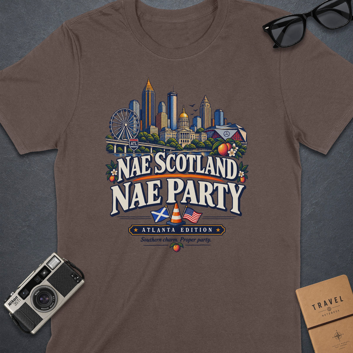 Brown t-shirt with Atlanta skyline graphic and "Nae Scotland Nae Party" text.