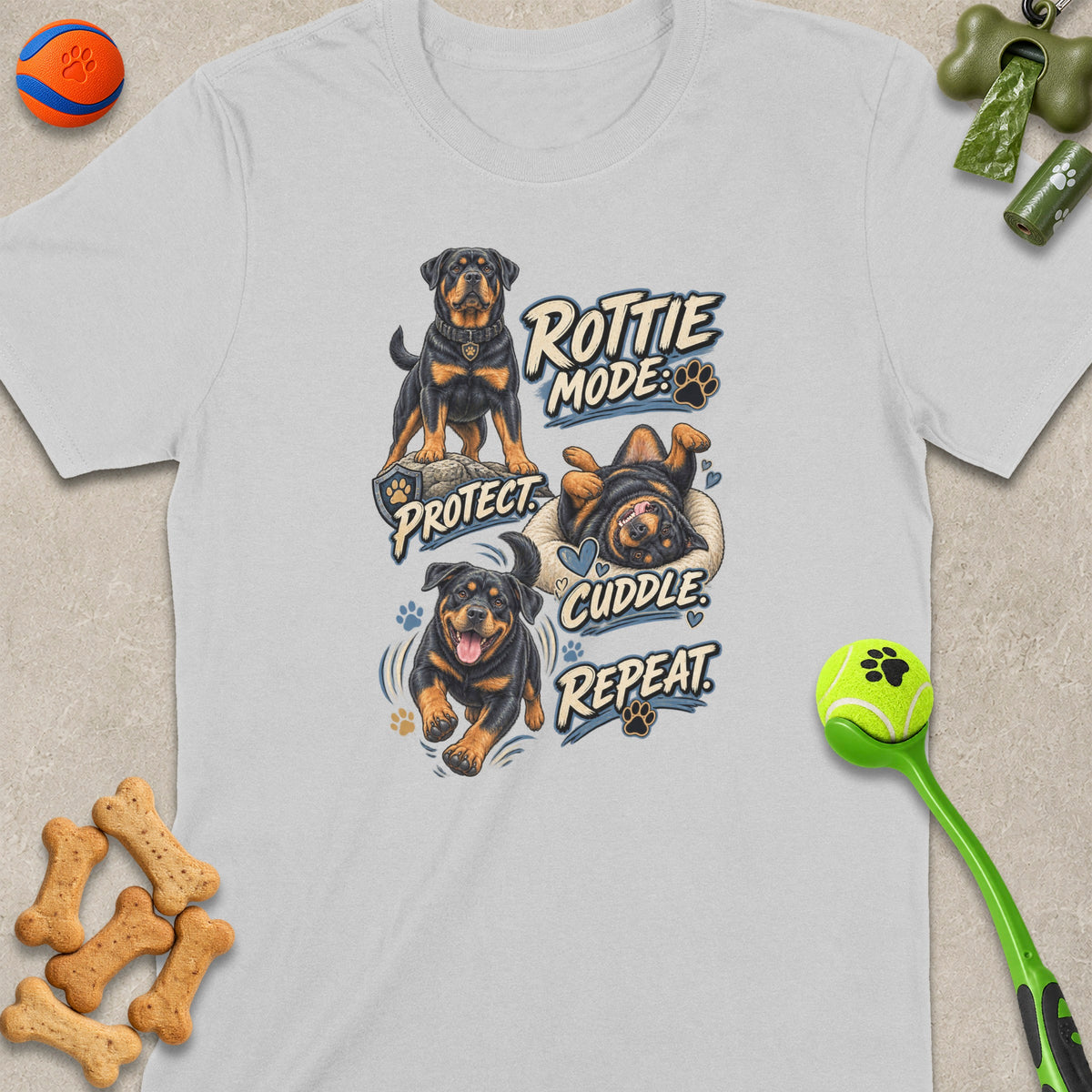 White t-shirt featuring Rottweilers in "Rottie Mode: Protect, Cuddle, Repeat" graphic.